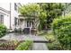Picturesque backyard featuring a stone patio, garden, and porch for outdoor enjoyment at 1002 Vance St, Raleigh, NC 27608