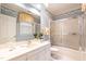 Bathroom with decorative wallpaper, vanity, and shower with sliding glass door at 1002 Vance St, Raleigh, NC 27608