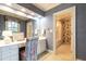 Bathroom with vanity and floral wallpaper, adjacent to shower with floral wallpaper at 1002 Vance St, Raleigh, NC 27608