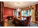 Well-appointed dining room with chandelier, wood table, and striking red walls at 1002 Vance St, Raleigh, NC 27608