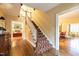 Elegant foyer with hardwood floors, staircase with patterned runner, and classic archway entrances at 1002 Vance St, Raleigh, NC 27608