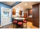 Eat-in kitchen featuring custom cabinetry, wood floors, and breakfast bar with seating at 1002 Vance St, Raleigh, NC 27608