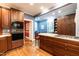 Kitchen with wooden cabinets, hardwood floors, and an island cooktop with seating at 1002 Vance St, Raleigh, NC 27608