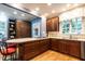 Well-lit kitchen with wooden cabinetry, an island cooktop and seating at 1002 Vance St, Raleigh, NC 27608
