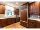 Spacious kitchen featuring wood cabinets, stainless appliances, and hardwood floors at 1002 Vance St, Raleigh, NC 27608