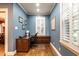 Home office with custom built-ins, wood floors, blue walls, and natural light at 1002 Vance St, Raleigh, NC 27608