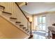 Bright foyer featuring a wooden staircase and view into the home's dining room at 1002 Vance St, Raleigh, NC 27608