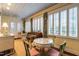 Charming sunroom featuring a decorative ceiling, piano, and bright windows with plantation shutters at 1002 Vance St, Raleigh, NC 27608