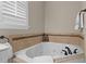 Close-up of a bathtub featuring a tiled surround and modern fixtures at 1012 Coram Fields Rd, Wake Forest, NC 27587