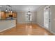 Open dining area with hardwood floors, modern light fixture, and seamless kitchen access at 1012 Coram Fields Rd, Wake Forest, NC 27587