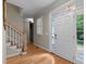 Welcoming entryway with hardwood floors, staircase, and natural light from the front door at 1012 Coram Fields Rd, Wake Forest, NC 27587
