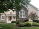 Charming two-story home with stone and vinyl siding and a well-manicured lawn at 1012 Coram Fields Rd, Wake Forest, NC 27587