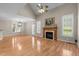 Bright living room with hardwood floors, fireplace, and ample natural light at 1012 Coram Fields Rd, Wake Forest, NC 27587
