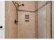Shower with glass door and tiled walls featuring a built-in niche at 1012 Coram Fields Rd, Wake Forest, NC 27587