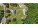 This aerial view showcases the home, a detached garage, and the surrounding lush greenery and spacious lot at 102 Ridge Ln, Youngsville, NC 27596