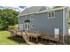 Rear view of the home showcasing the expansive deck, siding, and outdoor living space at 102 Ridge Ln, Youngsville, NC 27596