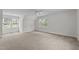 Spacious carpeted bedroom with ample natural light from multiple windows at 102 Ridge Ln, Youngsville, NC 27596