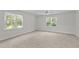 Bright bedroom with windows providing natural light and neutral carpet at 102 Ridge Ln, Youngsville, NC 27596
