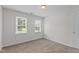 Empty bedroom with two windows and carpeted floor at 102 Ridge Ln, Youngsville, NC 27596