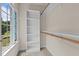 Walk-in closet with carpet and shelving unit next to window at 102 Ridge Ln, Youngsville, NC 27596