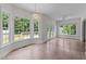 Bright dining area with big windows, a chandelier, and outside deck access through glass doors at 102 Ridge Ln, Youngsville, NC 27596