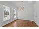 Well-lit dining room with hardwood floors, wainscoting, and ample natural light at 102 Ridge Ln, Youngsville, NC 27596