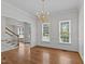 Formal dining room featuring hardwood floors, wainscoting detail, and a chandelier at 102 Ridge Ln, Youngsville, NC 27596