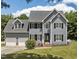 Charming two-story home boasts a manicured lawn, classic shutters, and an attached two car garage at 102 Ridge Ln, Youngsville, NC 27596