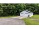 Spacious detached garage with ample parking, featuring dual doors and a well-maintained exterior, nestled in a green landscape at 102 Ridge Ln, Youngsville, NC 27596