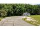 Garage exterior showcasing ample parking space, a paved driveway, and verdant surroundings at 102 Ridge Ln, Youngsville, NC 27596