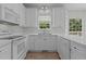Well-lit kitchen featuring white appliances, lots of cabinets, and a view from the window at 102 Ridge Ln, Youngsville, NC 27596