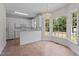 Bright eat-in kitchen featuring white cabinets, tile floors, and a large bay window at 102 Ridge Ln, Youngsville, NC 27596
