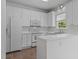 Spacious kitchen with white cabinets, modern appliances, and ample countertop space for cooking at 102 Ridge Ln, Youngsville, NC 27596