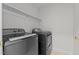Laundry room featuring modern gray washer and dryer and white shelving at 102 Ridge Ln, Youngsville, NC 27596