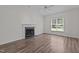 Bright living room with hardwood floors, fireplace, and a ceiling fan at 102 Ridge Ln, Youngsville, NC 27596
