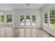 Bright room featuring big windows, glass doors, and vinyl plank and tile flooring at 102 Ridge Ln, Youngsville, NC 27596