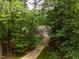 Beautiful home nestled among the trees with a long driveway and lush landscaping, providing privacy and tranquility at 103 Red Cedar Pl, Chapel Hill, NC 27514