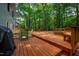 Spacious wooden deck featuring outdoor seating and a grill, perfect for outdoor entertaining in a wooded setting at 103 Red Cedar Pl, Chapel Hill, NC 27514