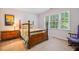 Bedroom featuring a bed, nightstand, rocking chair, and window to the outdoors at 103 Red Cedar Pl, Chapel Hill, NC 27514
