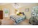 Bright bedroom featuring a large bed, exercise bike, and windows to the outdoors at 103 Red Cedar Pl, Chapel Hill, NC 27514