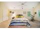 Bright bedroom featuring a large bed, ceiling fan, and windows with a view of the outdoors at 103 Red Cedar Pl, Chapel Hill, NC 27514