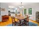 Dining area off kitchen featuring hardwood floors, adjacent to french doors leading to outdoor deck at 103 Red Cedar Pl, Chapel Hill, NC 27514