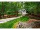 A beautiful house with a lush green front yard and a long driveway surrounded by mature trees at 103 Red Cedar Pl, Chapel Hill, NC 27514
