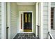 Close-up of a stylish front door with decorative glass panels and black hardware, set in a slate porch at 103 Red Cedar Pl, Chapel Hill, NC 27514