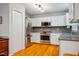 Bright kitchen with stainless steel appliances, including a refrigerator and oven at 103 Red Cedar Pl, Chapel Hill, NC 27514