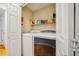 Convenient laundry room with a washing machine, dryer, and shelving at 103 Red Cedar Pl, Chapel Hill, NC 27514