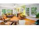 Cozy living room with large windows, hardwood floors, and a fireplace at 103 Red Cedar Pl, Chapel Hill, NC 27514
