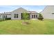 Lush green backyard featuring a patio, screened porch, and beautiful landscaping at 104 Spindle Dr, Durham, NC 27703