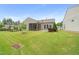 Well-maintained backyard with lush lawn, featuring both a patio and screened porch area at 104 Spindle Dr, Durham, NC 27703