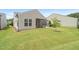 A beautiful backyard with a screened porch, patio, and lush green grass at 104 Spindle Dr, Durham, NC 27703